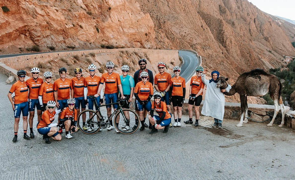 Group of cyclists with camels on a Bike Odyssey tour