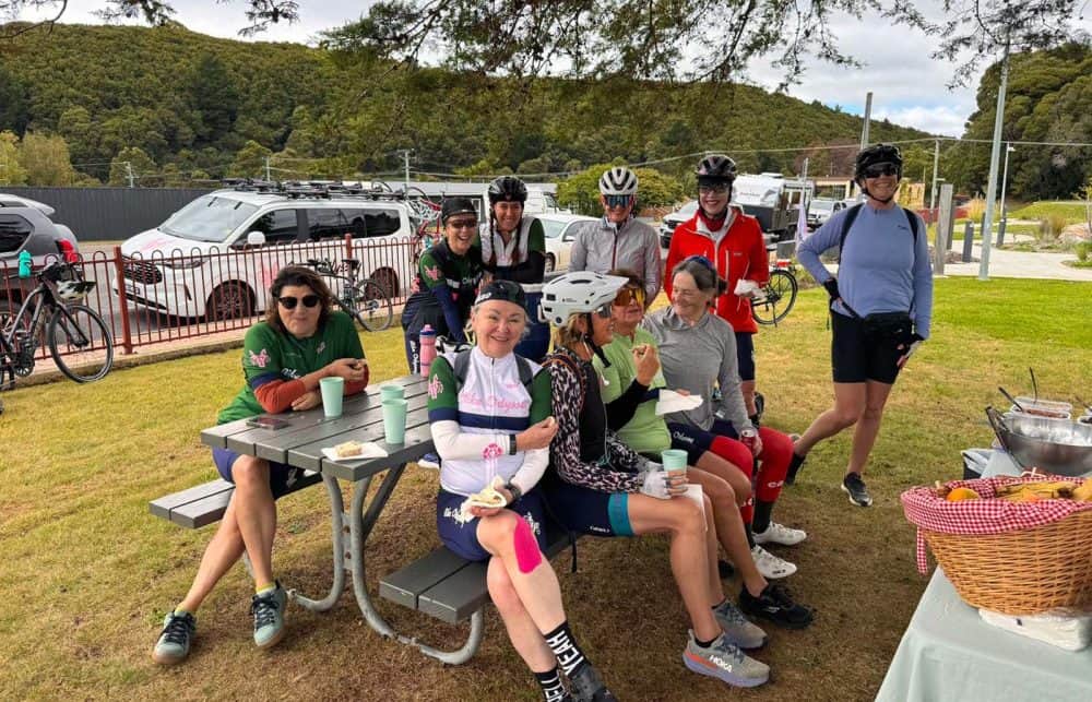 Morning tea at Zeehan with our March 2026 Tasmania group - nine riders, every one of whom came on their own.