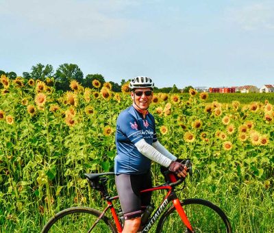 Allies Odyssey by Mich Jones Mitch Jones riding in front of sunflowers in France